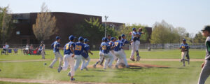NECC's baseball team, the Knights, jump and hug each other after a victory on the baseball diamond.