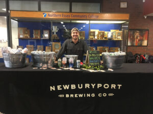 Newburyport Brewing Company has a table setup where they are serving beer
