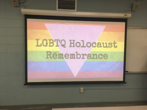 A slideshow, showing the LBGTQ flag with a pink triangle