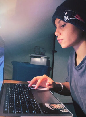 Mirrorajah Metcalf does schoolwork on her laptop in her bedroom.