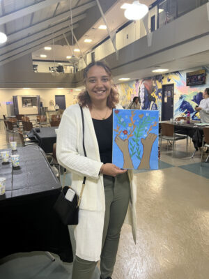Katiashka Perez holding her painting.