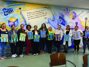 Participants in Unidos Paint Night show off their work in the Dimitry building on the Lawrence campus