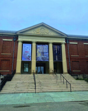 The front entrance of the Addison Art Gallery building is shown.