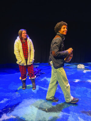 Two women on stage with wintry backdrop