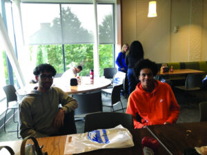Two students sit at a table at UMass Lowell.