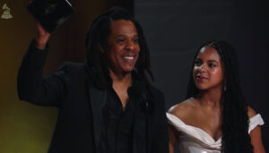 Jay Z and his daughter stand on stage at the Grammys.