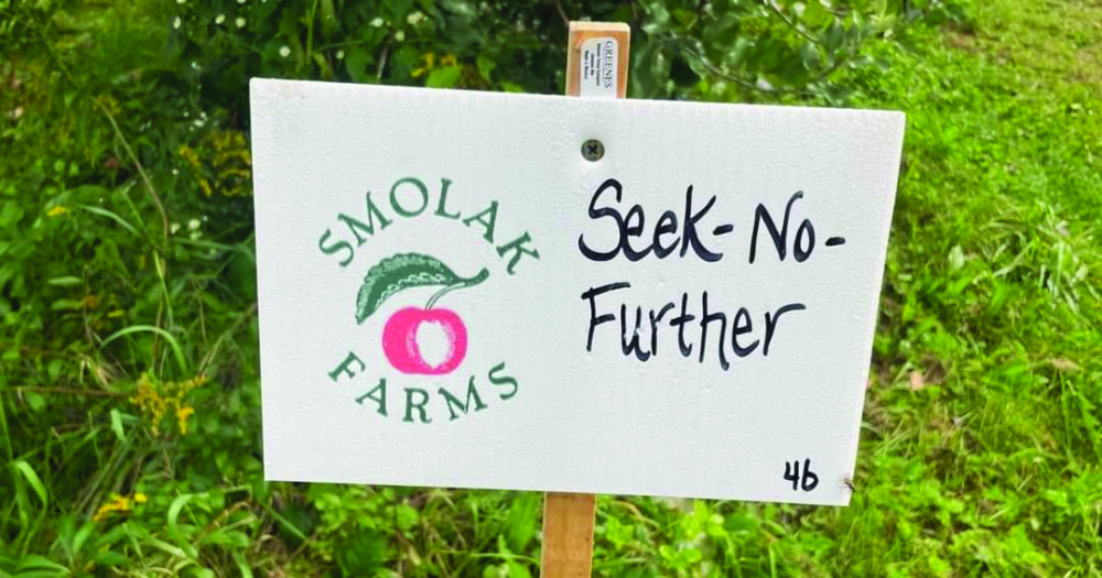 A sign of Smolak Farms saying "Seek no further"