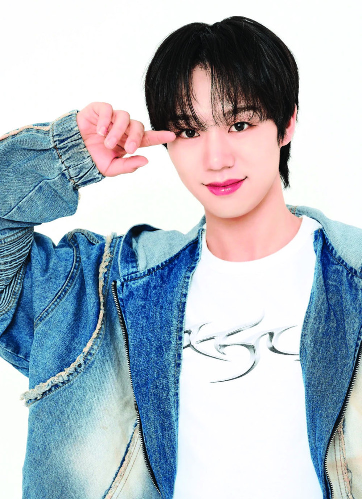 A man looking at the camera and saluting