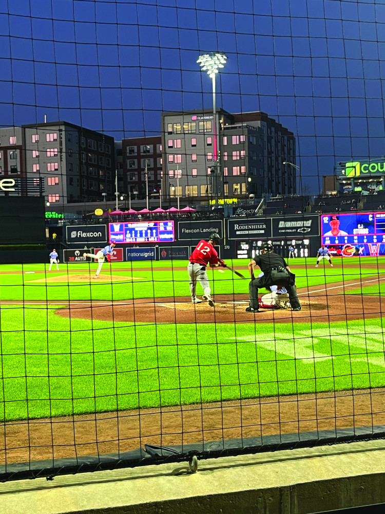 A baseball pitcher throws the ball to the batter