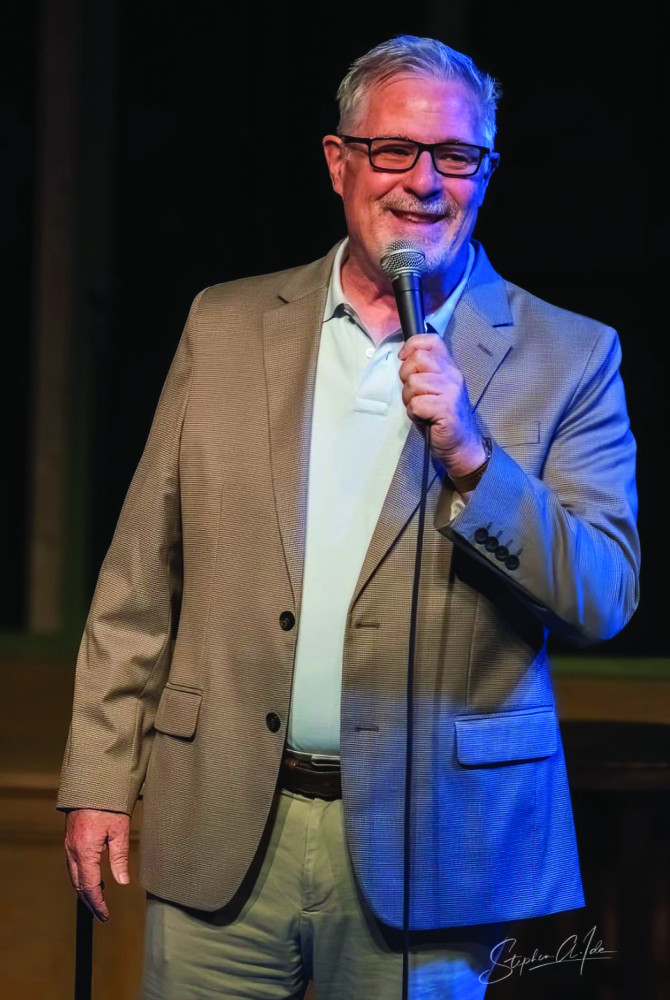 A man in a suit jacket holding a microphone