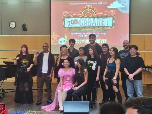 A group of people smile and pose for a group photo