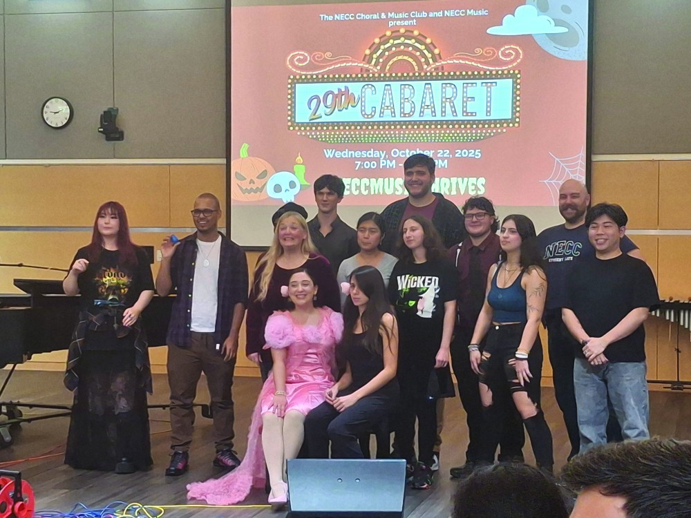 A group of people smile and pose for a group photo