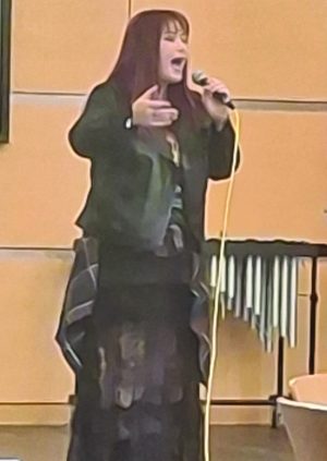 A woman sings with a microphone