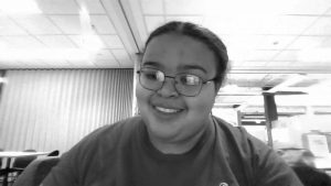 A photo of a woman looking into a computer camera