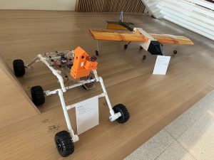 SNHU students’ projects displayed.Small models of a vehicle and a plane.