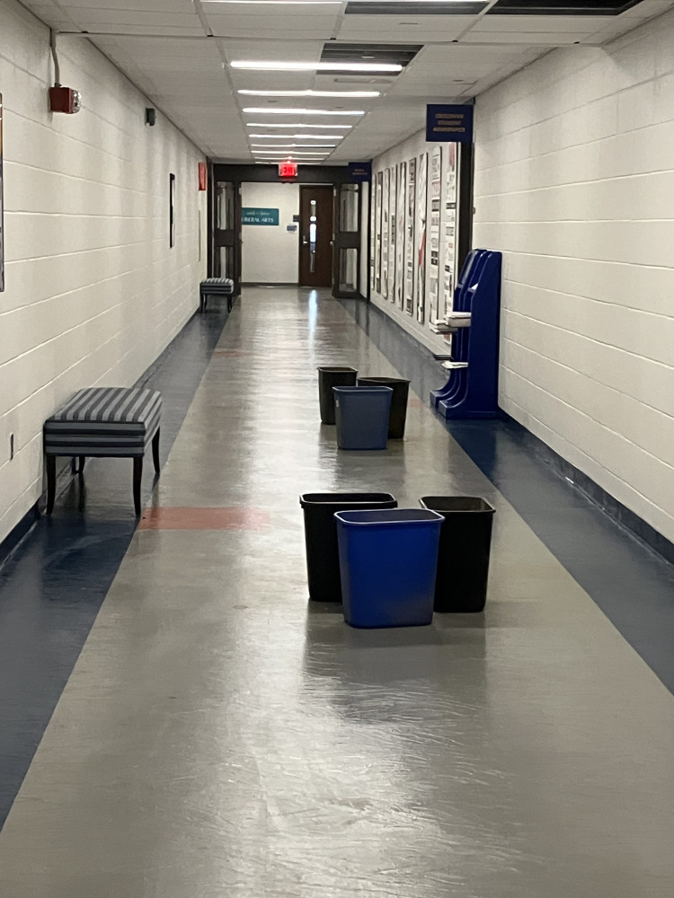 Buckets in a hallway in the C Spurk Building at NECC's Haverhill Campus.