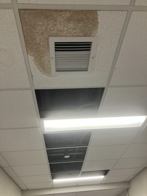 Missing ceiling tiles and water stain on the ceiling in the Spurk C Building on NECC's Haverhill Campus.