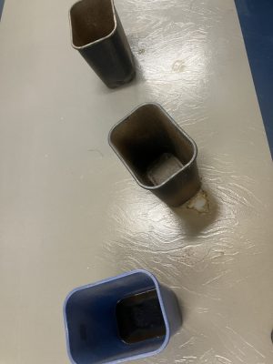 Trash cans fill with water in the hallway of the third floor of the Spurk C Building on NECC's Haverhill Campus.
