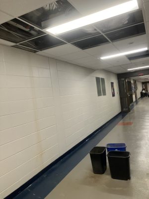 Trash cans catch water from leaking ceiling in third floor hallway of Spurk C Building on NECC's Haverhill Campus.