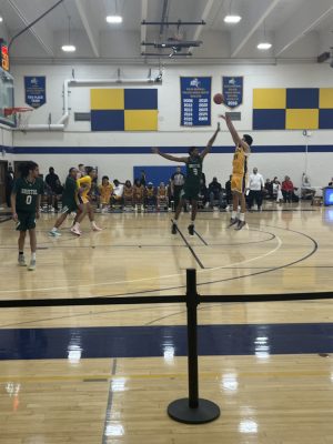 A basketball player shoots the ball at the basket