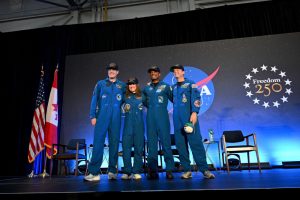 Four astronauts are posing for a picture