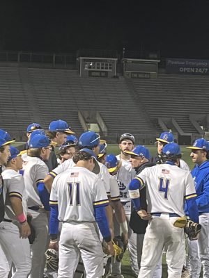 NECC coach Jeffrey Mejia talks to the team after their win against Bunker Hill.
