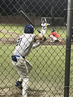 Another NECC baseball player practices his batting before the game against Bunker Hill.