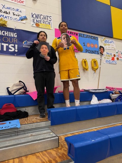 One women's basketball player and one men's basketball player are posing as they achieved 1,000 points for the season