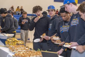 Basketball players eat food in the gym 