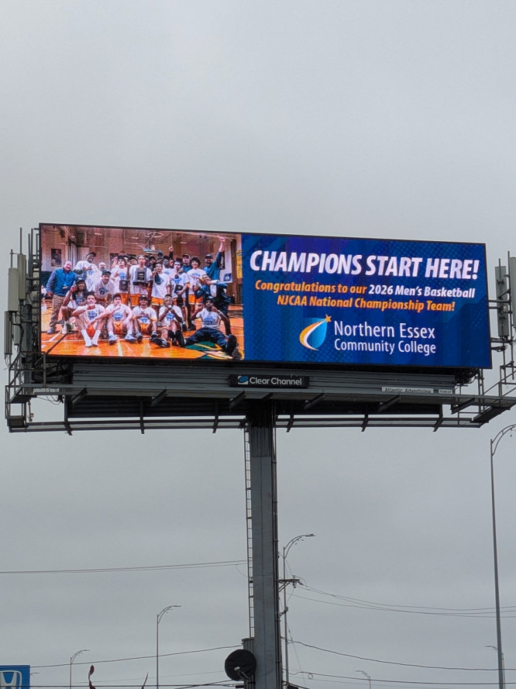 A billboard on Interstate 495 showcasing the NECC’s 2026 Men’s Basketball Team Nationals Championship