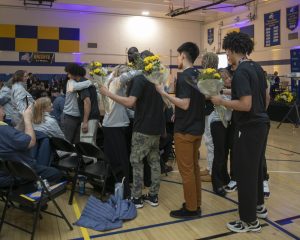 Basketball players give the academic coaches flowers. 